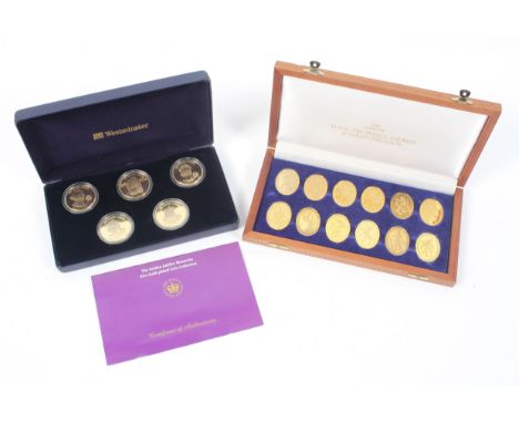 Two Commemorative coin sets, the first with twelve oval gold coloured coins with the Arms of HRH Prince Andrew &amp; Sarah Fe