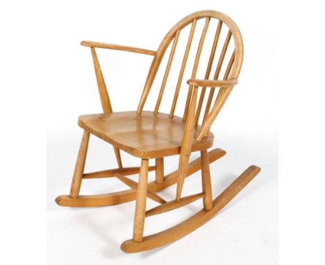 An Ercol beech and elm rocking chair, with spindle back, 74 cm high 