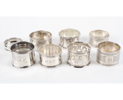 A collection of eight silver napkin rings, including two with engine turned decoration, another pierced, combined weight 180g