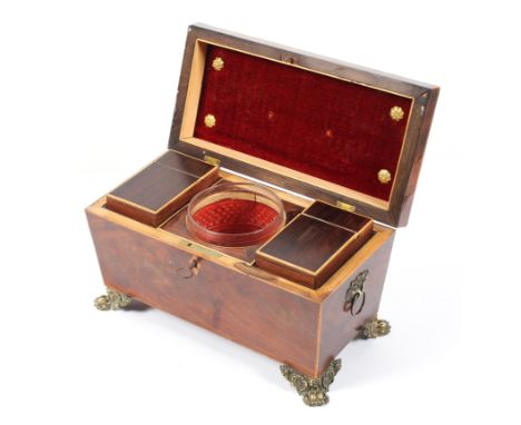 A Georgian inlaid mahogany sarcophagus shape tea caddy, with ring handles and raised on gilt metal claw feet, width 31cm