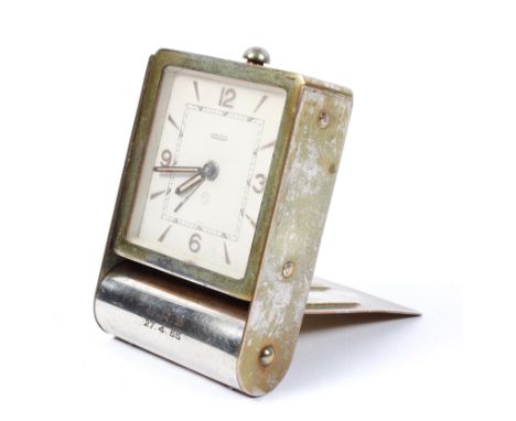 A vintage Jaeger-LeCoultre eight day travelling alarm clock, white dial with Arabic numerals and luminous hands, gilt case in