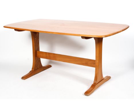 An Ercol dining table, in light elm, of rounded rectangular form on a trestle type base, 72cm high x 150cm long x 85cm wide