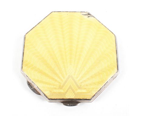 A George V silver and enamel octagonal compact, hallmarked Birmingham 1922, the cover with yellow engine turned decoration, d