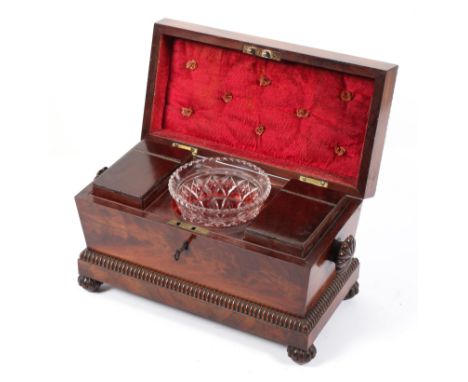 A William IV mahogany sarcophagus shaped tea caddy, with gadrooned borders and bun feet, the hinged cover revealing two hinge