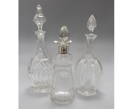 A silver mounted decanter and two other decanters