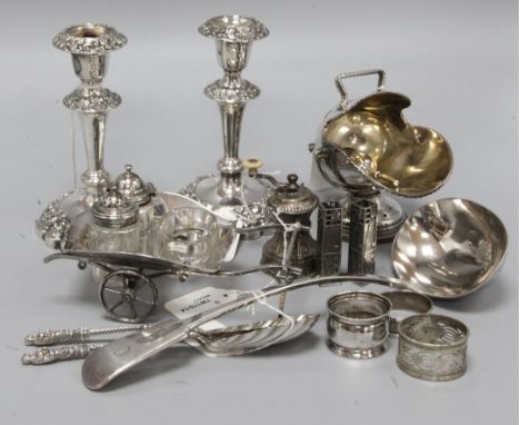 A small collection of plated items, including a Victorian wheelbarrow cruet set, a pair of candlesticks, a pair of apostle sp