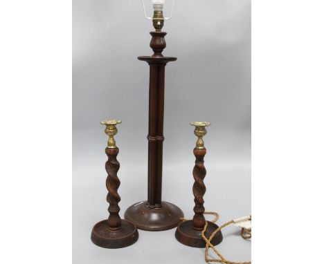 A wooden lamp and a pair of candlesticks