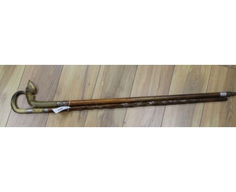 A silver mounted horn walking stick and a de-activated shot gun walking cane