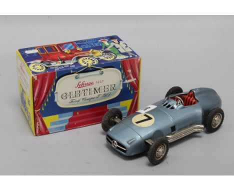 A Schuco 1227 Old Timer Ford Coupe model, boxed and a Western Germany tinplate model of a Mercedes racing car