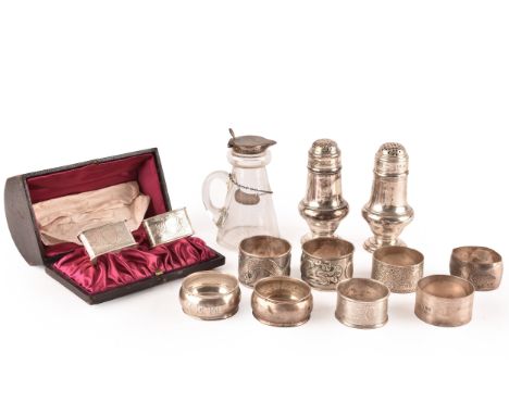 A boxed pair of Victorian triangular silver napkin rings with engraved foliate detail, engraved initials, hallmarked for Birm