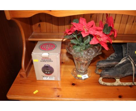 A glass vase with artificial flowers together with a 'Time Bomb' alarm clock 