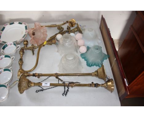 A quantity of brass light fittings and glass shades