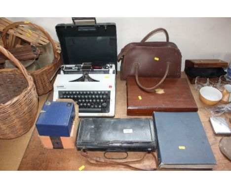 A metal carrier and an Olympia typewriter; a leather bag containing one bowling wood; a cutlery box etc. 