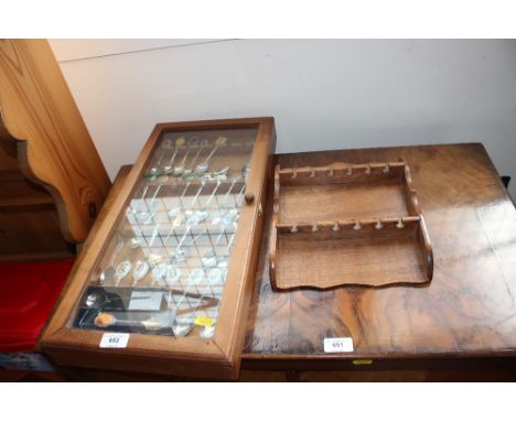 A display case and contents of souvenir spoons and a spoon rack