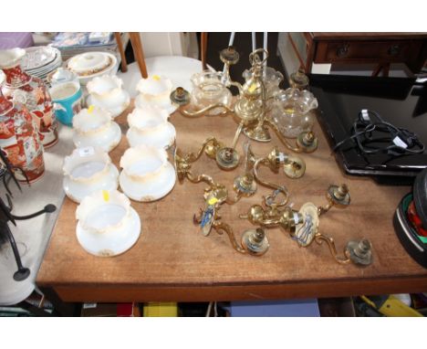 A brass ceiling light with two wall lights to match with floral decorated glass shades 