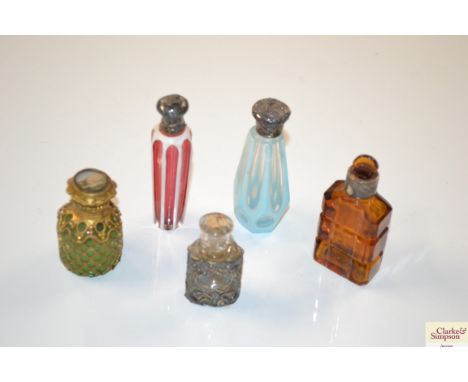 A ruby overlaid glass scent bottle with silver mount and four others 