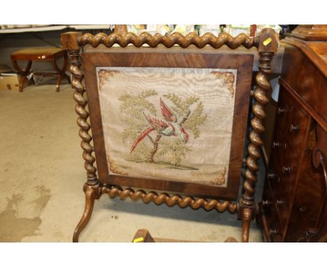 A Victorian mahogany fire screen with tapestry panel and barleytwist supports 