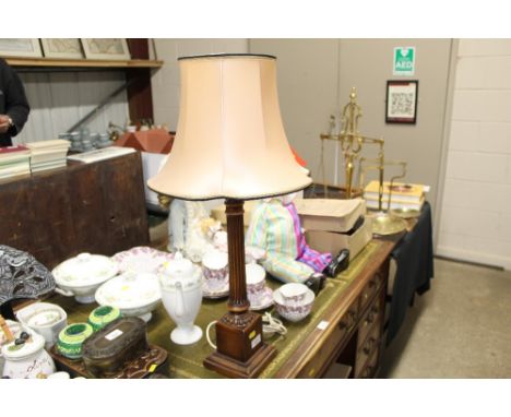 A mahogany Corinthian column style table lamp and shade 
