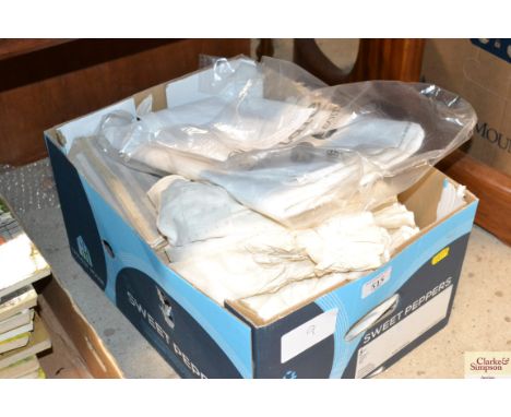 A box containing antique linen tablecloth and various other linen 