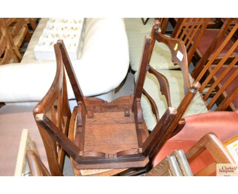 A ladder back and cane seated chair and a hardwood stool