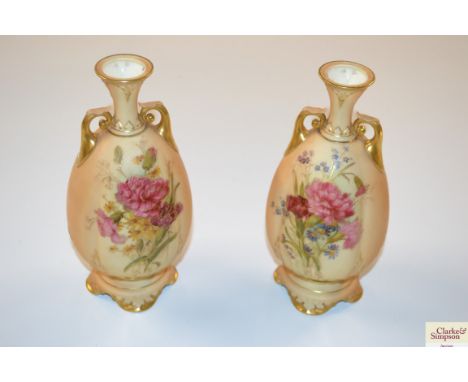 A pair of late 19th / early 20th Century Royal Worcester porcelain vases, having floral decoration on a  blush ivory ground