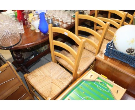 A set of four beech ladder back dining chairs 
