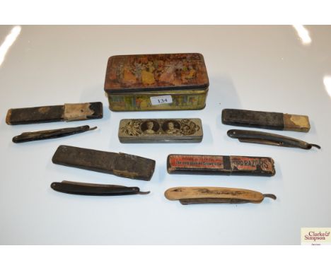 A vintage tin and contents of cut throat razors and a King George V coronation tin