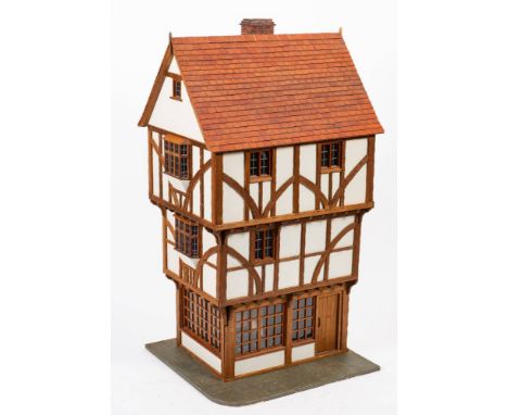 A scale model of the 16th century Merchant House, Exeter 'The House That Moved' with title roof and brick chimney over to tim