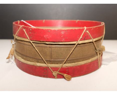 A WWI period scratch built toy drum constructed from a tin, bentwood, string and recycled engineering drawings 25cm diameter,