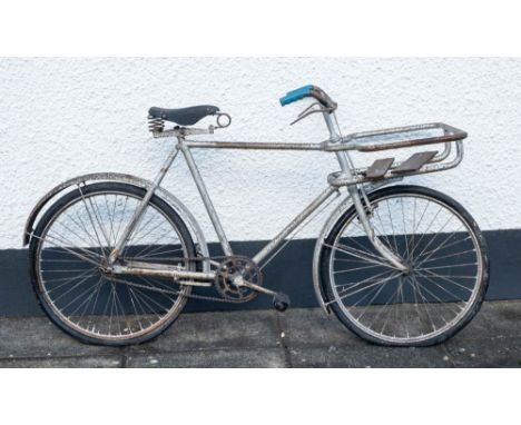An overpainted delivery bicycle:, maker unknown, with pannier frame to front, lever brakes and black leather Dunlop saddle.