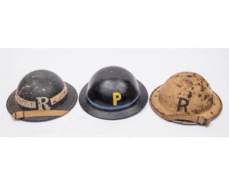 Two WWII MK I steel  helmets: one in black with 'R' and  rank stripe, tether in white with 'R' together with a WWII Cromwell 