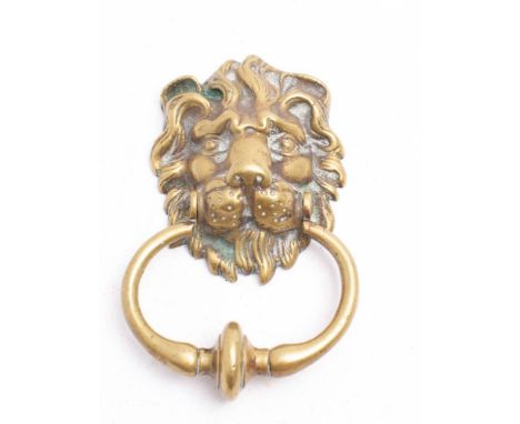 A late Victorian/Edwardian brass lion's mask door knocker: with knopped bow, 16cm high.