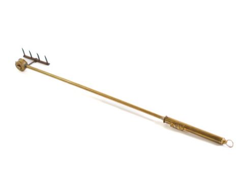 A brass 'Magic 318' patent revolving toasting fork: with metal tines.