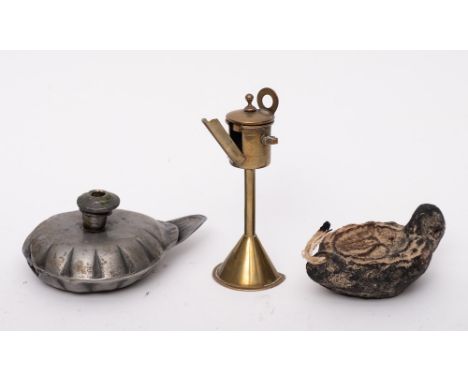A miniature Dutch brass oil lamp: on cone-shaped base, 12cm high, a pewter oil lamp of Romanesque form, 12.5cm and a Roman po