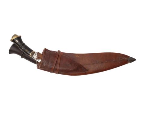 An ebony handled  Kukri: in brown leather scabbard. 