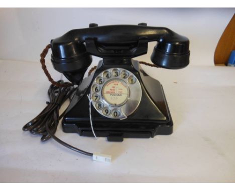 A model 232 bakelite telephone hand set: with integral drawer and braided handset cord. 23cm wide. 