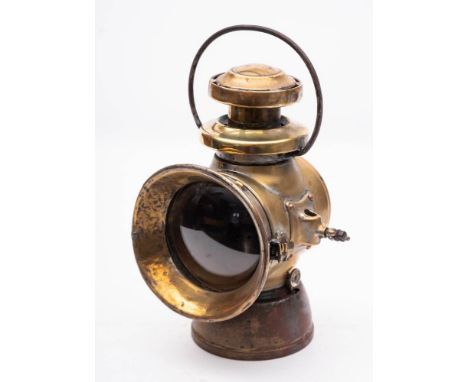 A Lucas No.740 King of The Road  oil lamp:  with fixed  carrying bail and wing nut side claps, bracketed lens cover and oil r