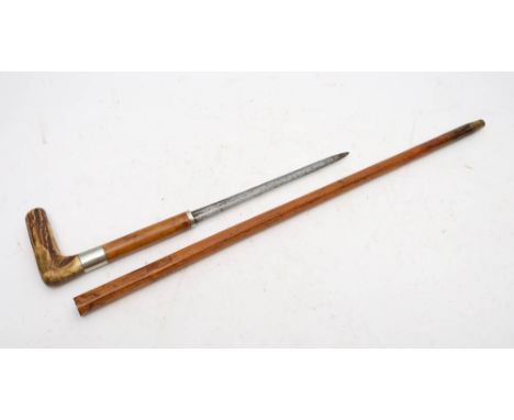 A late 19th century swordstick, the short double sided blade within a malacca shaft with antler handle and silver plated ferr