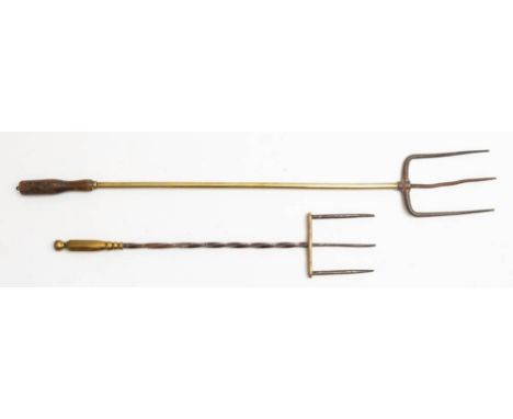 A metal and brass three pronged fork: with spiral stem and polygonal handle and a metal and brass three pronged fork with tur