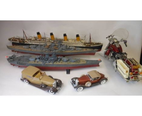 A collection of constructed plastic ship, motorcycle and car models: includes RMS Titanic, Bismark, Yamoto two saloon cars an