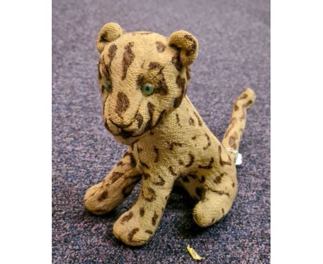 Steiff or similar. A mid 20th century plush leopard  with green glass eyes, stitched nose and mouth with moveable head on a s