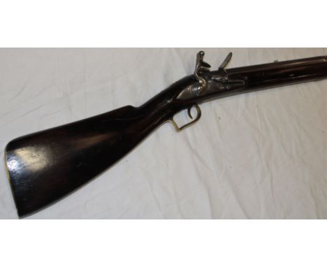 A late 18th / early 19th century flintlock military musket with 42" steel barrel, engraved steel lock marked "Tower" with wal