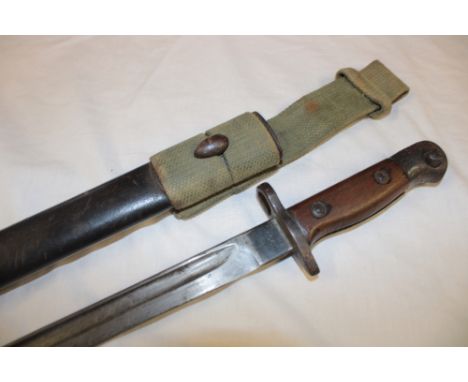 A Second War Lee Enfield bayonet with single edged blade dated 1937 in leather scabbard with webbing frog