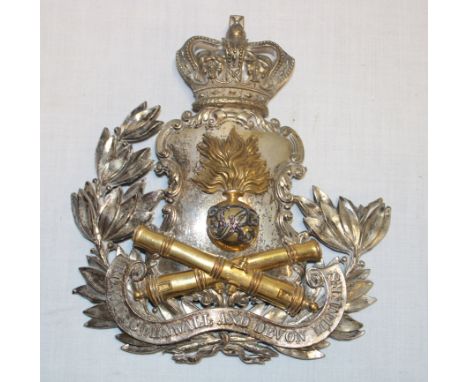 A scarce Victorian officers silver gilt helmet plate of the Royal Cornwall and Devon Miners Artillery Militia with gilt cross