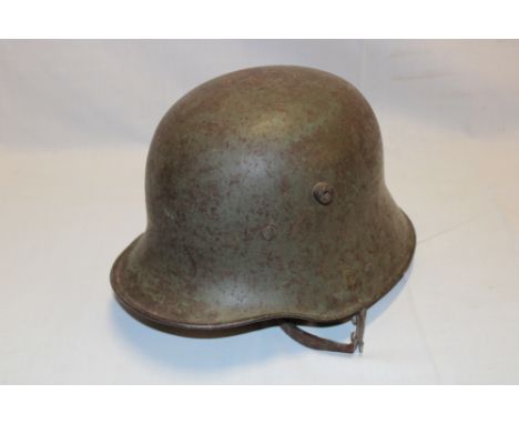 An original First War model 1916 German steel helmet with original green paint finish, leather liner and chin strap 