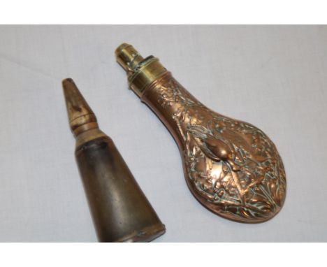 An 18th century cow horn powder flask with tapered stopper and a 19th century copper and brass mounted powder flask decorated