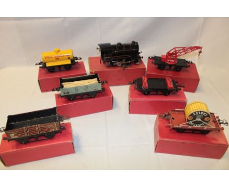 A Hornby O gauge - No. 50 clockwork reversing tank locomotive in original box and six various boxed good wagons including She