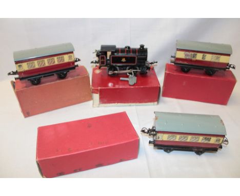 A Hornby O gauge - BR clockwork reversing tank locomotive, two boxed No. 51 coaches and a boxed passenger brake van (4)