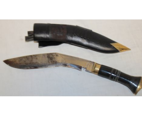 A Nepalese military issue kukri with 10½" curved single-edged blade stamped "Nepal 2015" in leather sheath