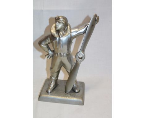 An unusual aluminium table lighter in the form of a standing airman holding a propeller 11" high 